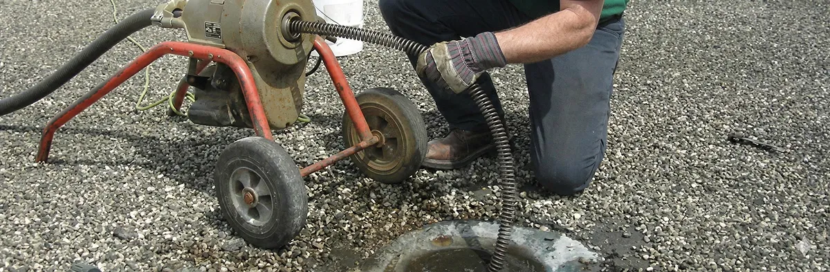 sewer rodding technician actively removing blockages from a sewer line in Orlando, FL